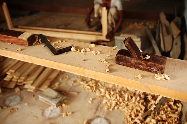 Block Plane and other Carpentry tools on Teak Wood Plank in Carpenter Workshop